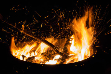 Beautiful flame with sparks in bonfire in the night. Heat and danger energy concept. Fire in...