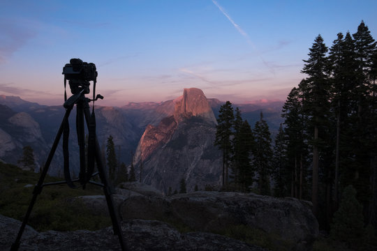 DSLR Camera & Tripod with Orange Sunset, Half Dome - Yosemite National park, California - Powered by Adobe