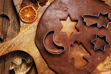 Baking ingredients for homemade pastry on wooden background with cookies and spieces