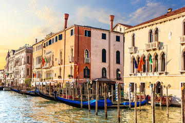 Venice palaces and gondolas in summer sun in the Grand Canal