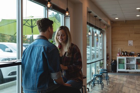 Couple interacting with each other in cafe