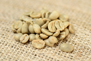 green coffee grains on burlap, macro