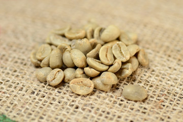 green coffee grains on burlap, macro