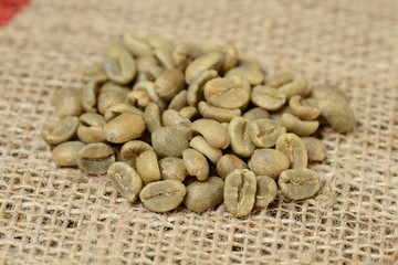 green coffee grains on burlap, macro