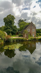 Fototapeta na wymiar Orangery of castle Ter Horst with reflections in the moat surrounding the castle in The Netherlands