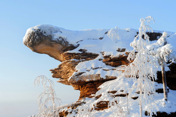 fancy weathered snow-covered rock against a blue sky