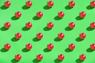 Pomegranate on green background