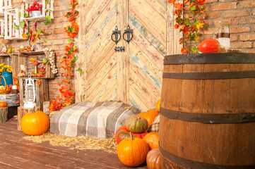 Autumn yellow leaves, pumpkins, autumn, straw, wooden door on the background.