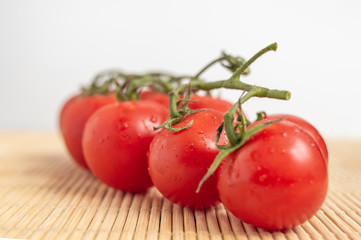 Red tomatoes on a wooden surface