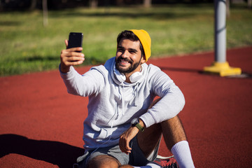 Sporty man resting and make selfie