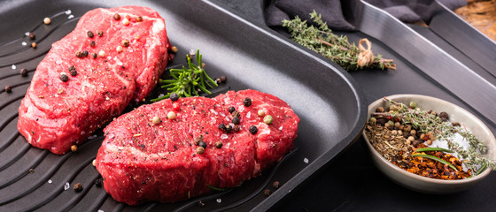 Two beef steaks seasoned in a pan