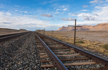 Train tracks into the distance with cliffs and telephone line
