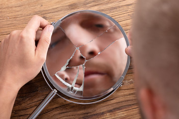 Man's Face In Broken Mirror