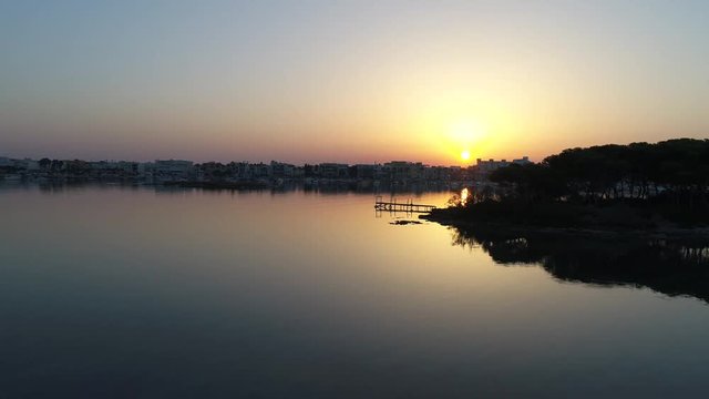 The sunrise seen from the Isola dei Conigli located in Italy, in Porto Cesareo, a small fishing village.