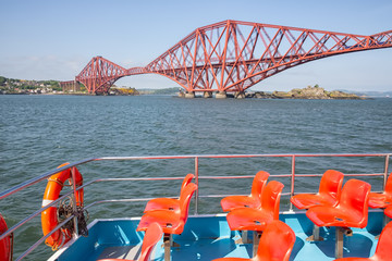 Launch boat making a round trip near Forth Railroad Bridge