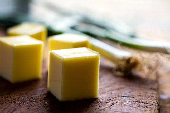 Close up of cheese cubes on a wooden table
