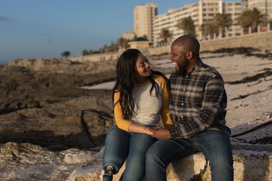 Couple sitting on beach - Powered by Adobe