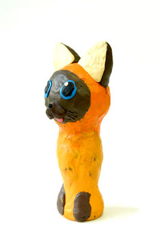 Plasticine figure of Kotenok Gav on a white background. Children's creativity