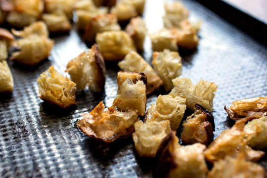 Close up of grilled bread pieces on baking tray