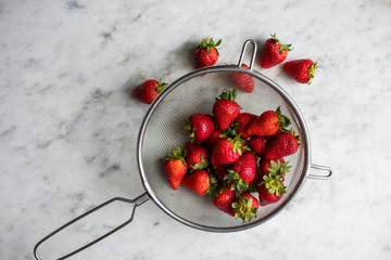 Overhead view of strawberries in sieve