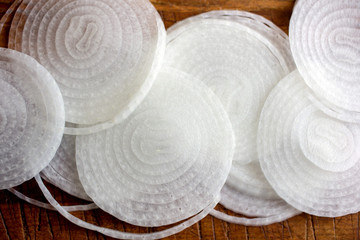 Close up of onion slices on a wooden table