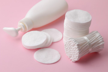 Body and skin care products in white packaging on a pink delicate background. Personal hygiene products.