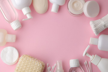 Body and skin care products in white packaging on a pink delicate background. Personal hygiene products. View from above. with space for text