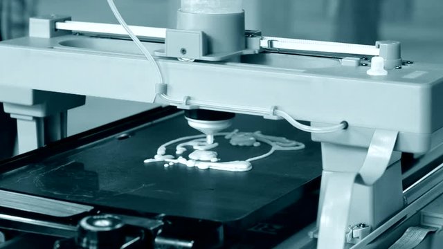 3d printer for liquid test. 3D printer printing pancakes with liquid dough different shapes close-up. Modern additive technologies 4.0 industrial revolution. Gray blue white colors.