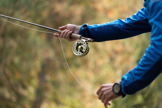 Fisherman holding fishing rod