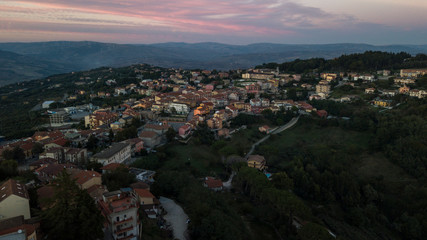 Aerial view at sunset of the small town of Montecalvo Irpino, in the province of Avellino, in Italy. This village with few houses and streets is built in the mountains of Irpinia.