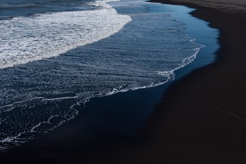 waves on the black sand beach