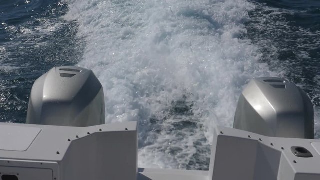Slow motion view from boat with two outboard motors. Turbulent, churning white water wake. Quintana Roo, Mexico.