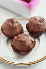 Chocolate hand made candy on the white plate