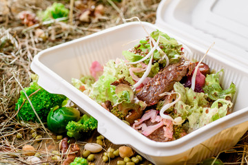 Healthy food delivery. Take away for diet. Fitness nutrition, vegetables, meat and fruits in eco boxes. at wood and straw with copy space. series of photos