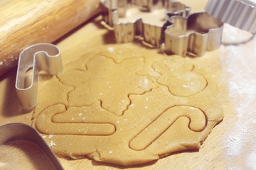  Christmas gingerbread cookie dough with flour, cookie cutter and plunger