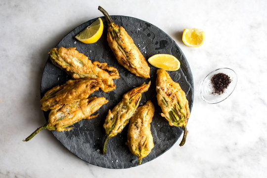 Close up of crisp courgette flowers stuffed with goat cheese