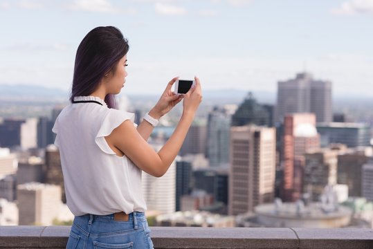 Woman clicking photo on mobile phone