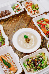 Healthy food delivery. Take away for diet. Fitness nutrition, vegetables, meat and fruits in white eco boxes. Top view, flat lay at natural wood with copy space