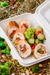 Rolls with vegetables, meat, omelette. Healthy food delivery. Take away for diet. Fitness nutrition, vegetables, meat and fruits in eco boxes. at wood and straw with copy space. series of photos