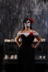 Portrait of zombie woman with white face and red flower on her head