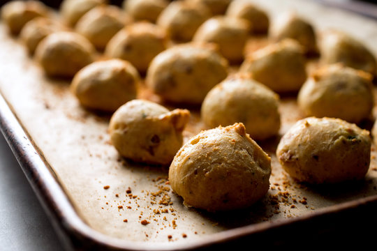 Close up of pancetta and sage gougeres on baking tray