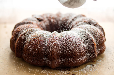Close up of powdered sugar dusting on chocolate cake
