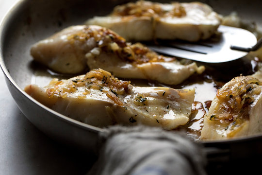 Close up of cod frying in frying pan