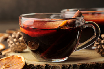 Hot mulled wine with cinnamon and orange in glass cups against a dark background. Christmas. new Year. close-up