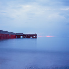 An abandoned pier on the Tuscan sea in Autumn at sunset with long exposure effect with slide film photography - 7