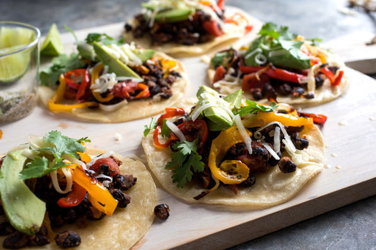 Close up of tostadas with black beans and peppers