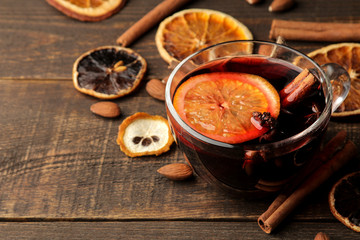 Hot mulled wine with cinnamon and orange in glass cups against a dark background. Christmas. new Year.