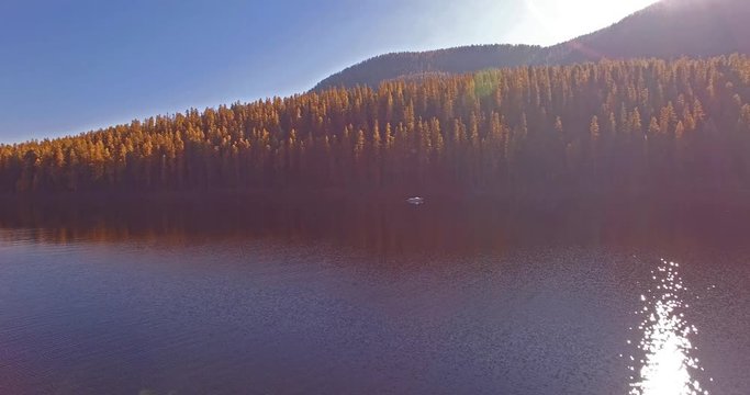 Aerial Drone Shot in Montana on a lake with a boat in the Fall or Autumn