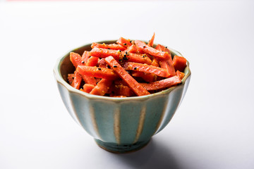 Carrot Pickle / Gajar ka Achar or Loncha in hindi. Served in a bowl over moody background. Selective focus