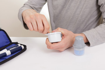 Fototapeta premium sensor diabetes checkup glucose man system sugar monitoring scan test hand skin medicine syringe table white background